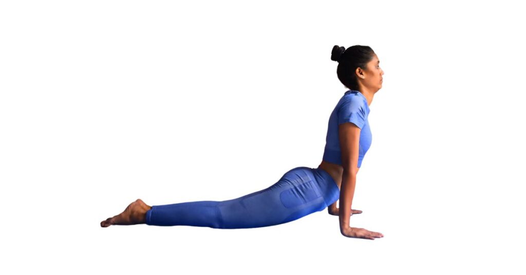 a female yoganta yoga teacher is in Cobra Pose (Bhujangasana)
